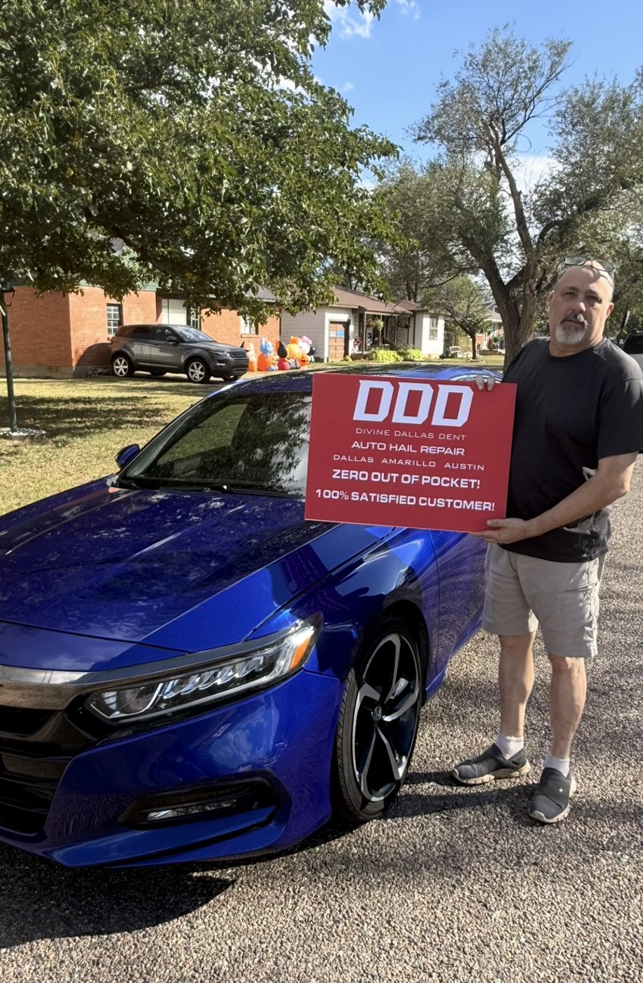 Customer holding a Divine Dallas Dent sign in front of a blue Honda Accord after hail repair