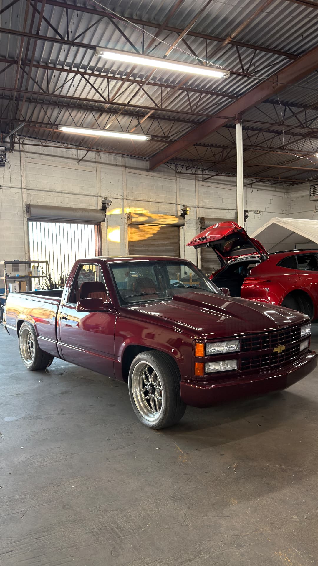 Custom maroon Chevrolet pickup truck rebuilt inside the shop