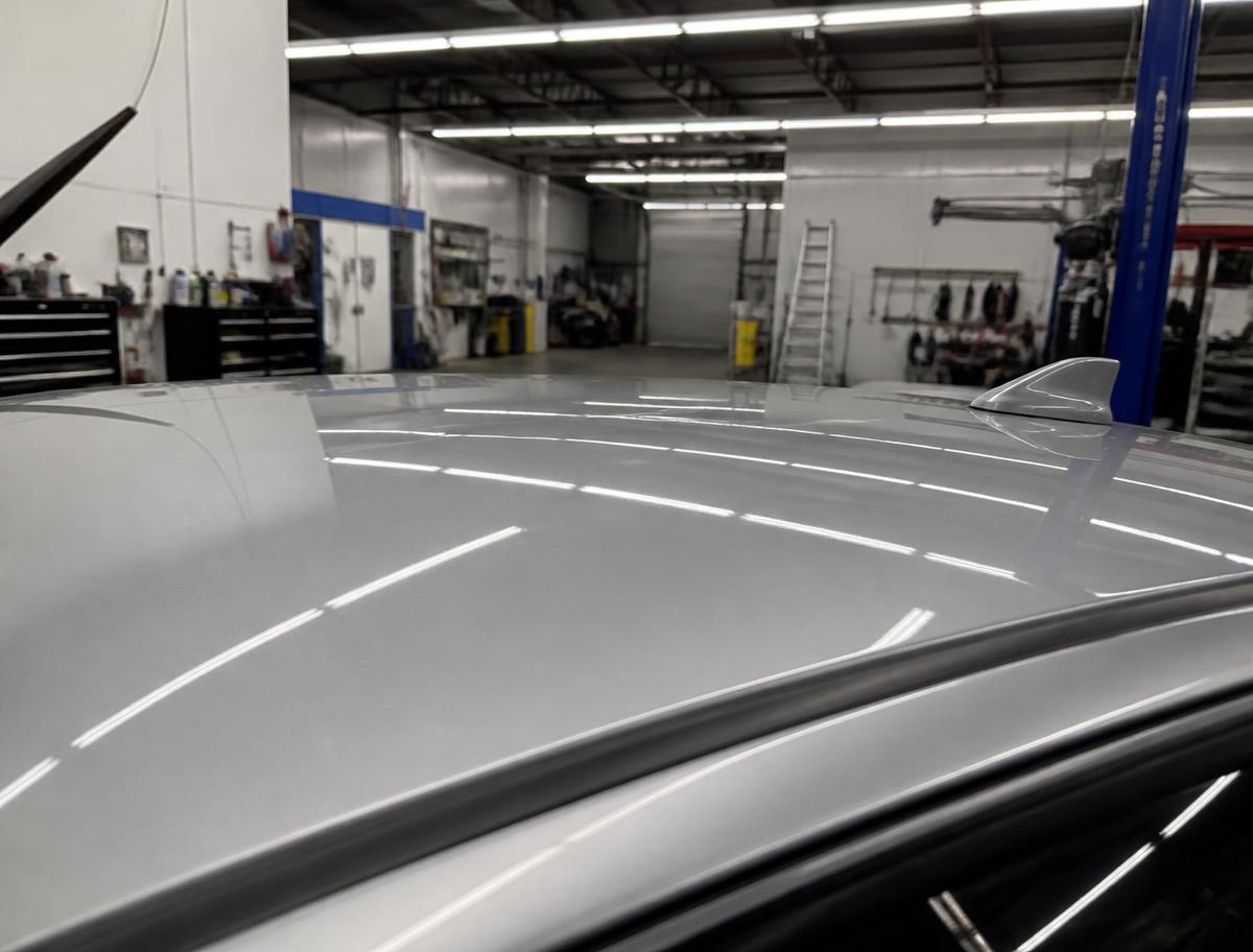 Completed hail repair with original factory paint — Roof panel — heavy storm damage