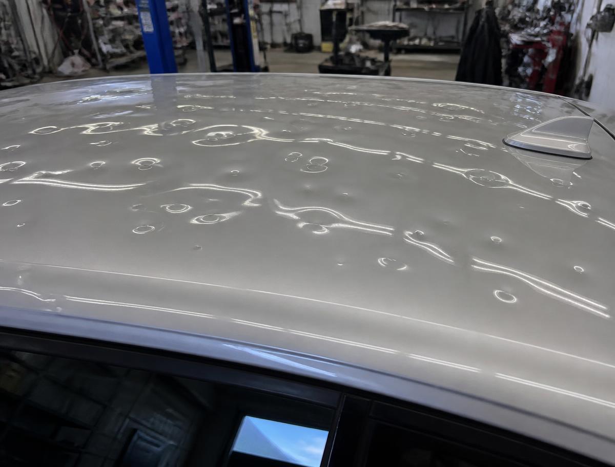 Hail damage before paintless dent repair — Roof panel — heavy storm damage